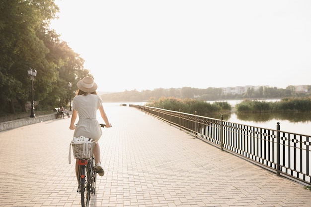 Young woman against nature background with bike