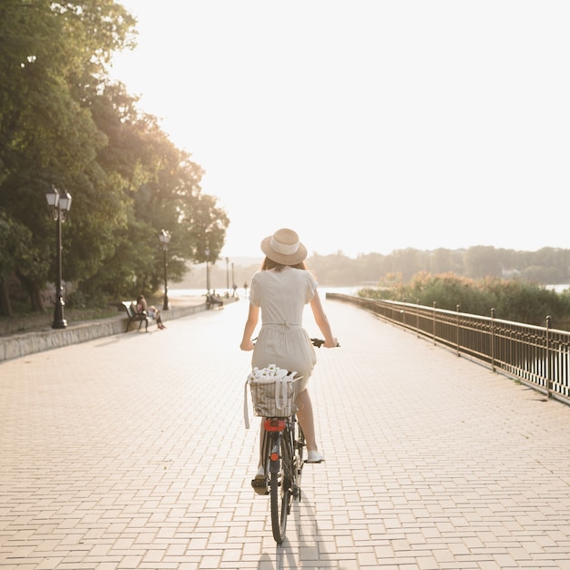 Young woman against nature background with bike