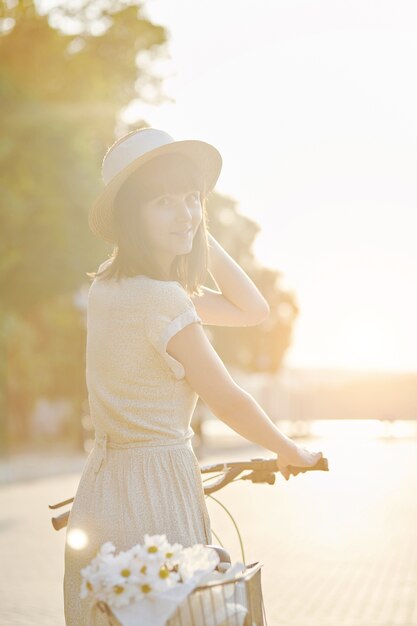 Young woman against nature background with bike