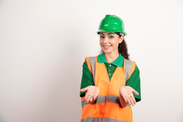 Young woman architect in uniform and helmet. High quality photo