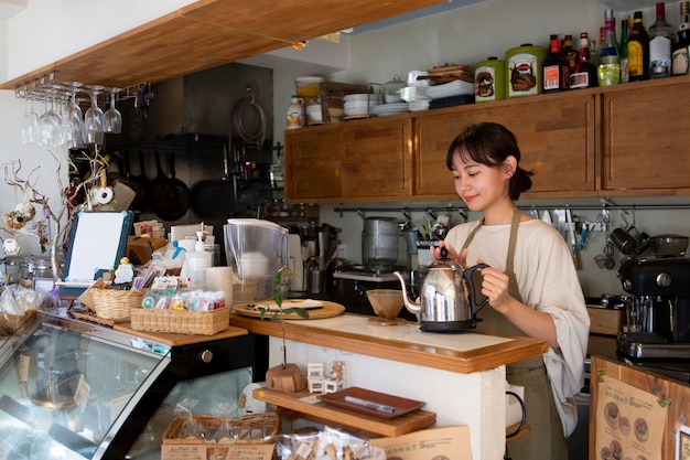 Young woman arranging her cake shop