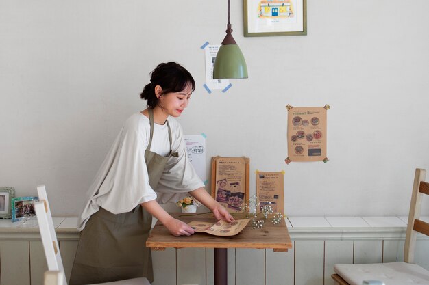 Young woman arranging her cake shop