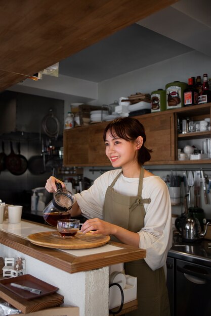 Young woman arranging her cake shop