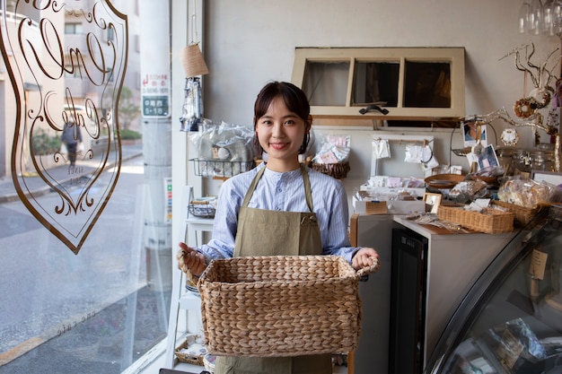 Free photo young woman arranging her cake shop