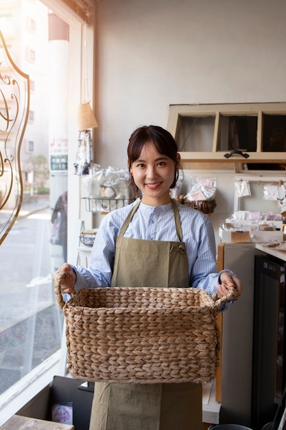 Free photo young woman arranging her cake shop