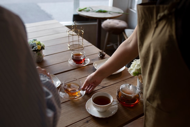 Free photo young woman arranging her cake shop