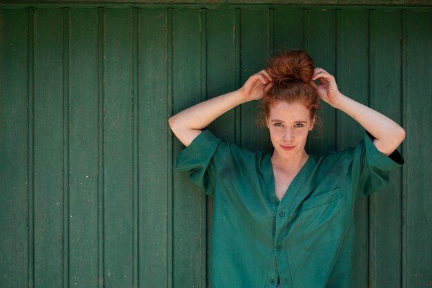 Young woman arranging her hair