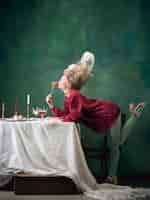 Free photo young woman as marie antoinette on dark