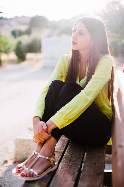 Young woman on bench in park