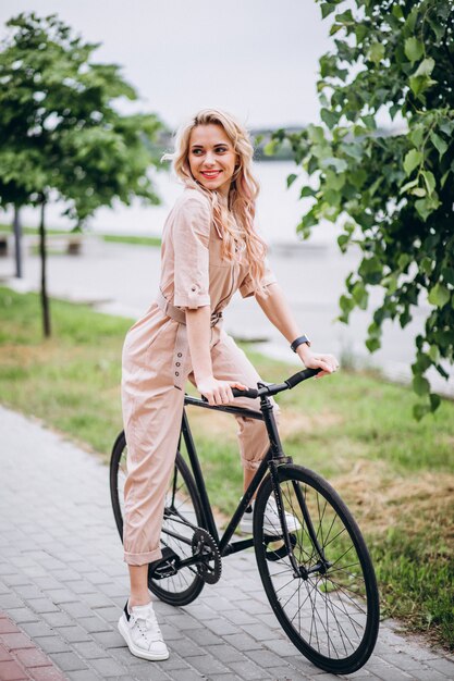 Young woman on a bicycle in park