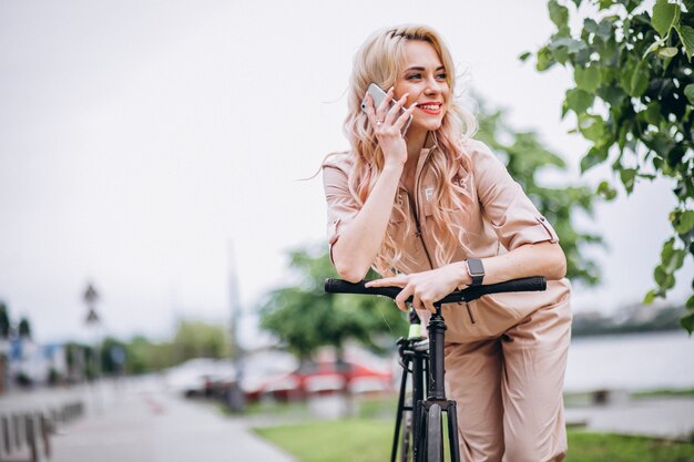 Young woman on a bicycle in park