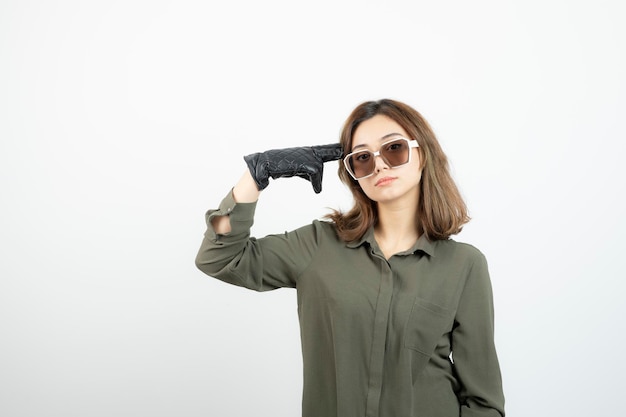 Free photo young woman in black gloves and eyeglasses posing and standing. high quality photo