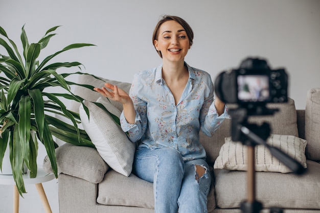 Young woman blogger recording video on camera