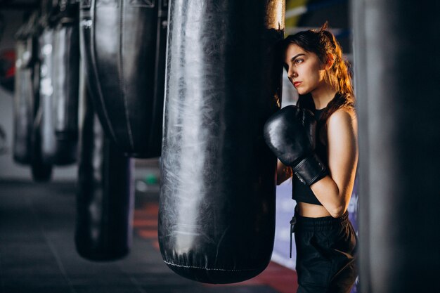 Young woman boxer training at the gym