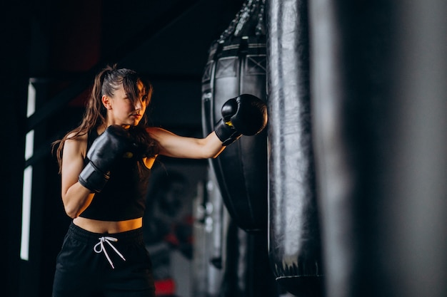 Free Photo young woman boxer training at the gym