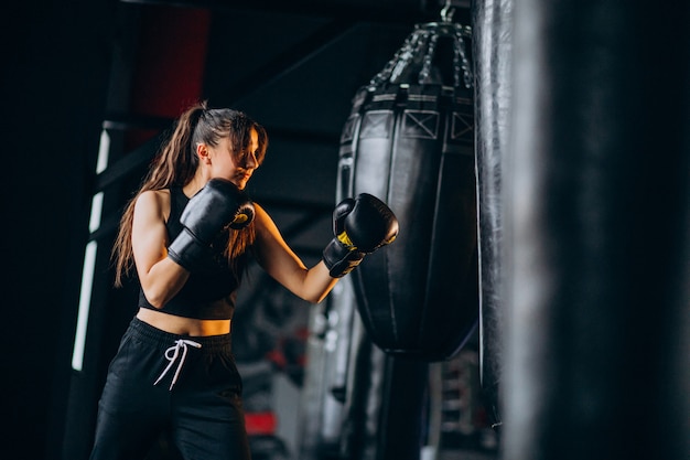 Young woman boxer training at the gym