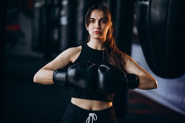 Young woman boxer training at the gym