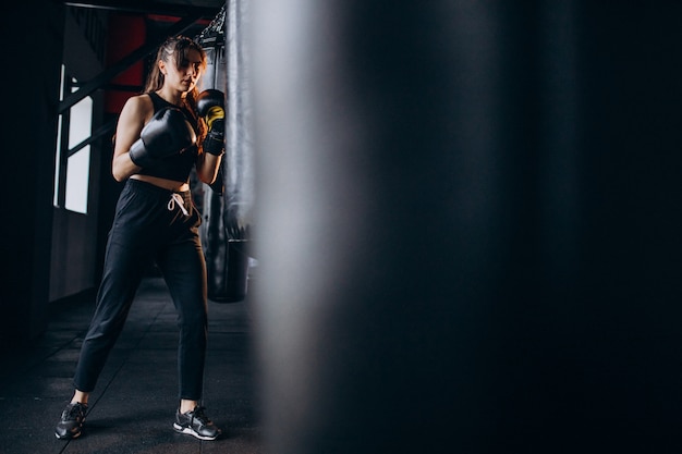 Free Photo young woman boxer training at the gym