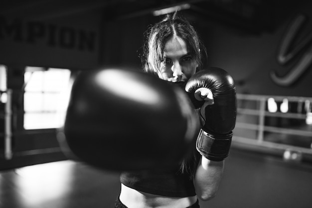 Free Photo young woman boxer training at the gym