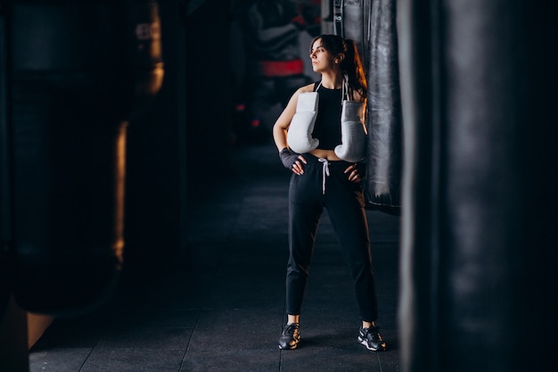 Free photo young woman boxer training at the gym