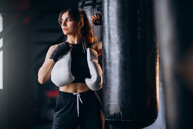 Young woman boxer training at the gym