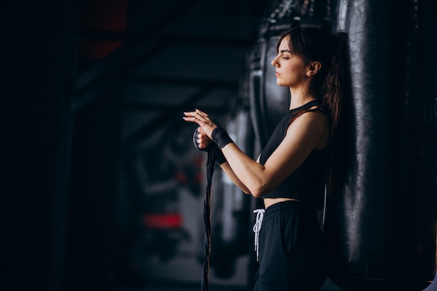 Young woman boxer training at the gym