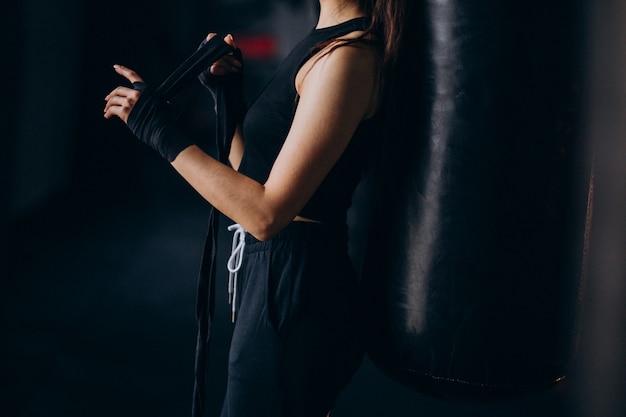 Free photo young woman boxer training at the gym