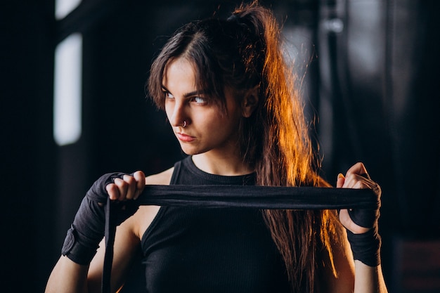 Young woman boxer training at the gym