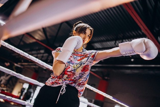 Free Photo young woman boxer training at the gym