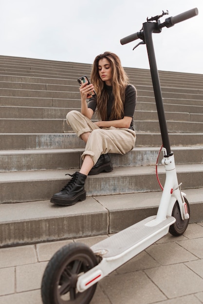 Free photo young woman browsing her mobile phone