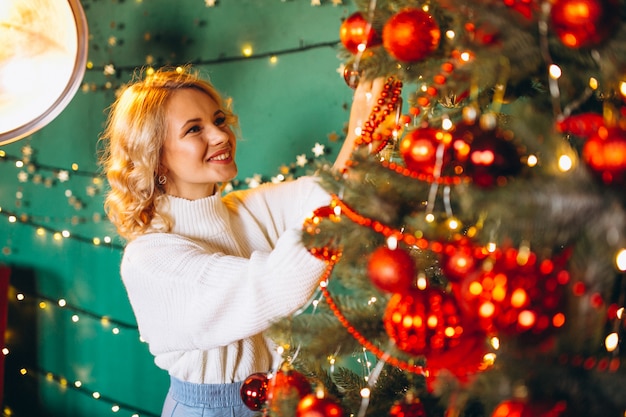 young woman by the Christmas tree on Christmas