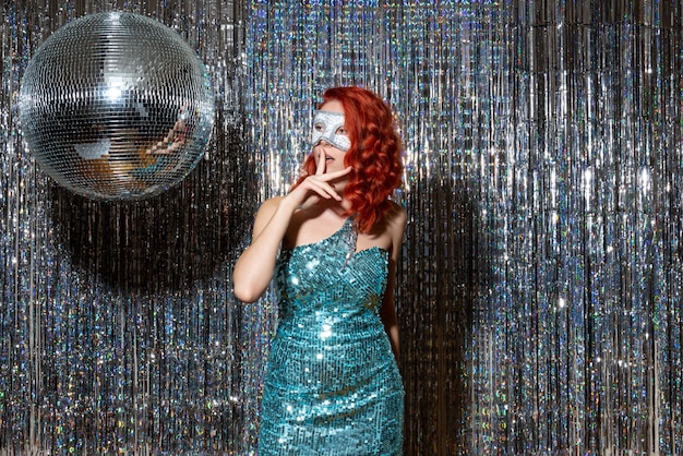 Free Photo young woman celebrating new year in mask on bright curtains