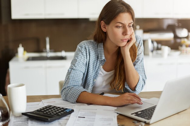 Young woman checking her budget and doing taxes