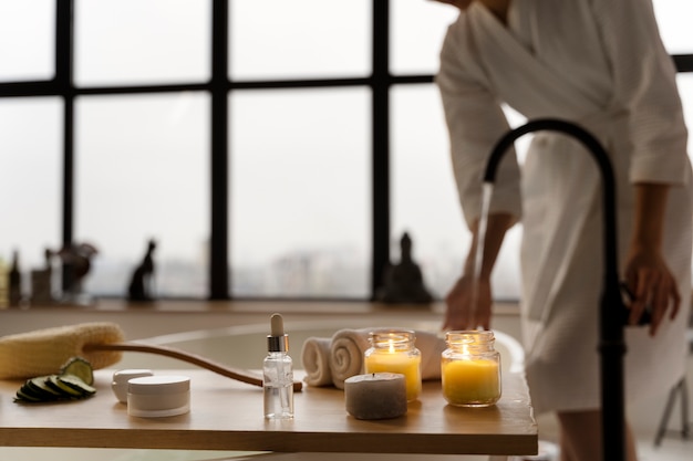 Young woman checking the water before taking a bath