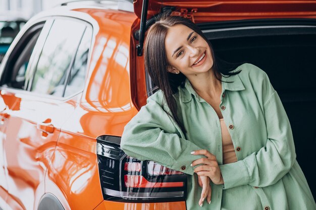 Young woman choosing a car for herself