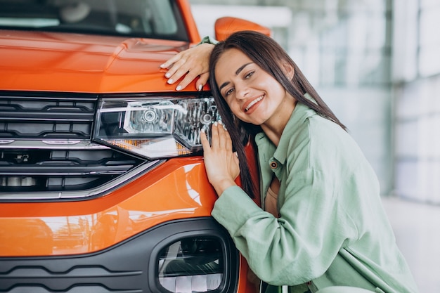 Free photo young woman choosing a car for herself