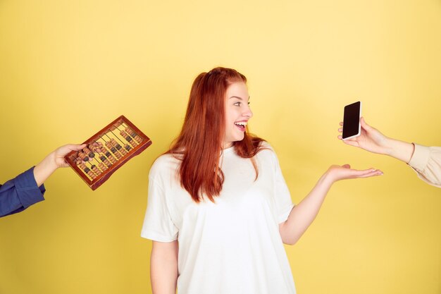 Free photo young woman choosing modern technology