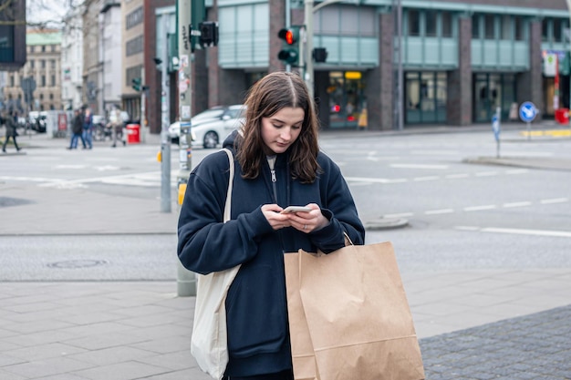 A young woman in the city on the street with a package shopping concept