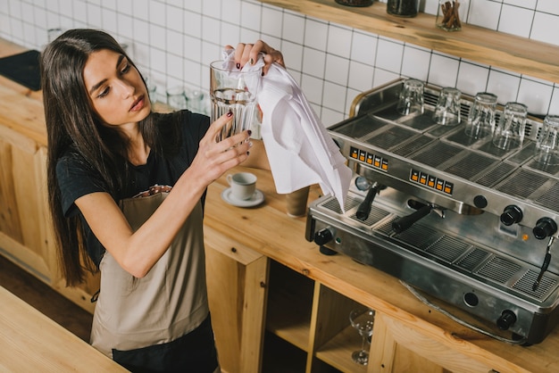 Free photo young woman cleaning glass