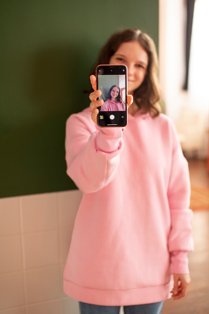 Free photo young woman connected to her smartphone