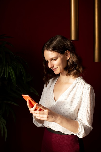 Free Photo young woman connected to her smartphone