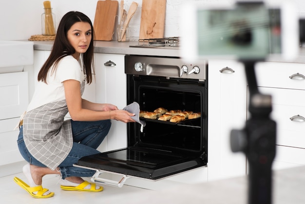 Young woman cooking for a video