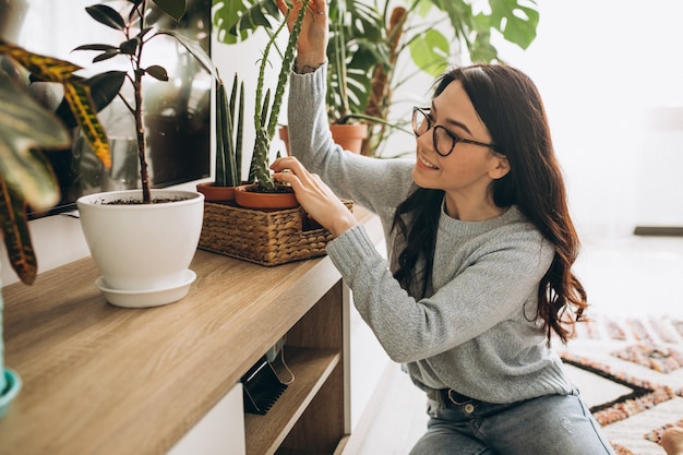 Young woman cultivating plants at home