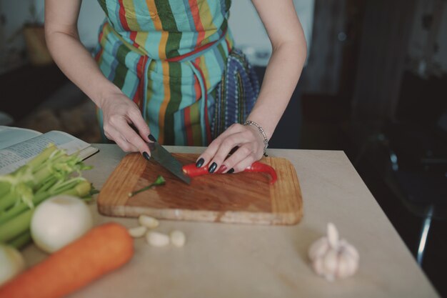 Young woman cutting vegetables