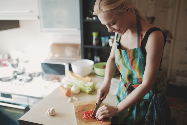 Young woman cutting vegetables