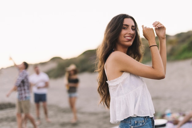 Free photo young woman dancing at the beach