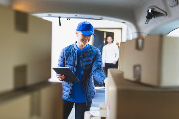 Free photo young woman delivering mail to client