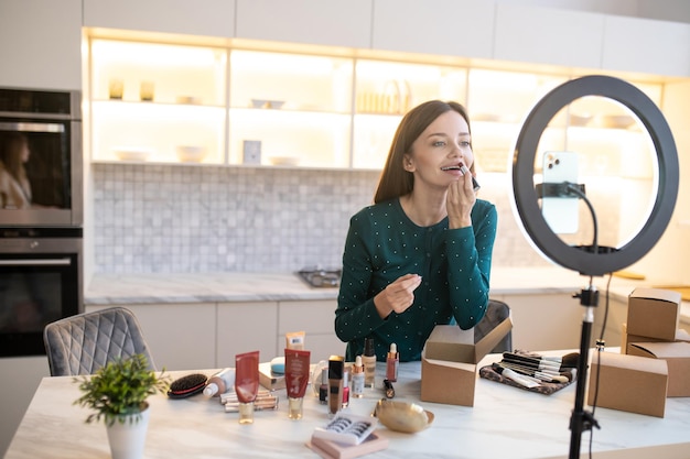 Free Photo young woman demonstrating new lip gloss and looking excited