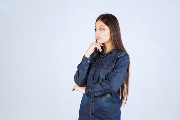 Young woman in denim shirt giving neutral and seductive poses without reactions