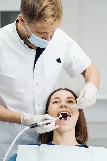 Young woman at the dentist chair during a dental scaling procedure